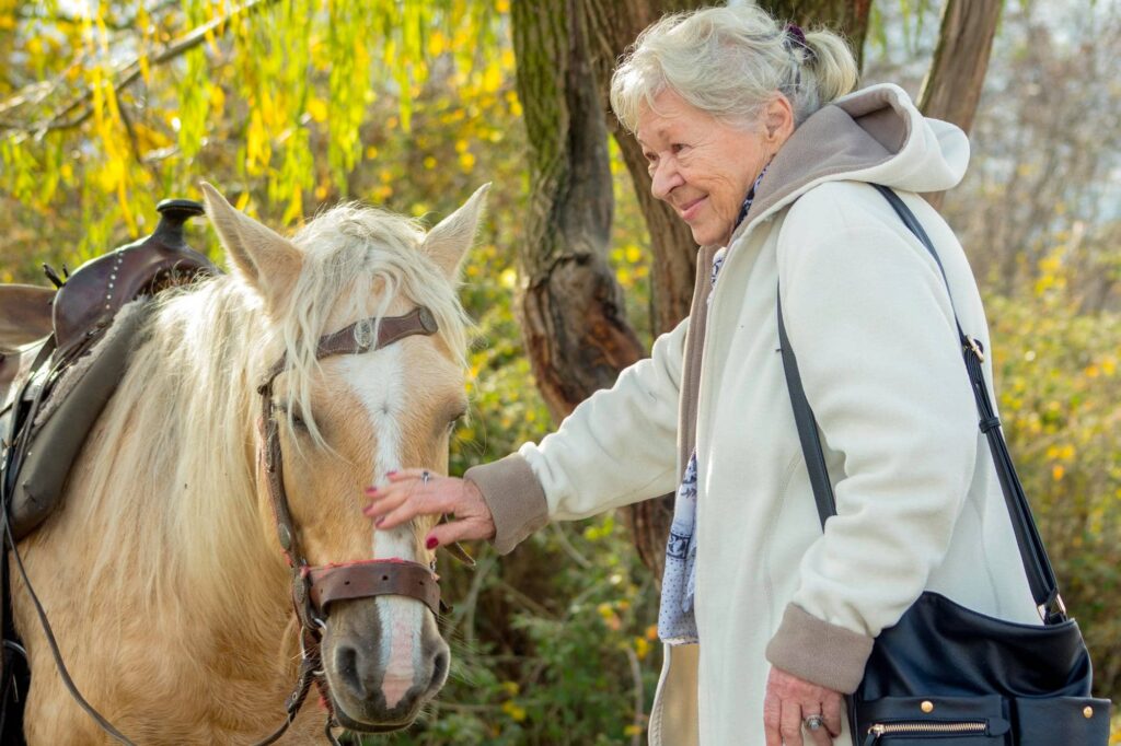 Anciana que muestra a que edad se puede montar a caballo